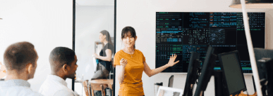 ey-female-programmer-interacting-with-colleagues-while-giving-presentation-in-office-background.jpg.rendition.1800 (1).png